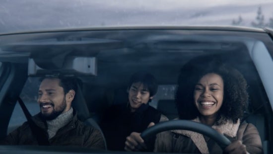 Three passengers riding in a vehicle and smiling | Sansone Nissan in Woodbridge NJ