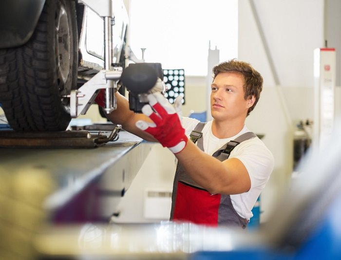 A mechanic performing a wheel alignment